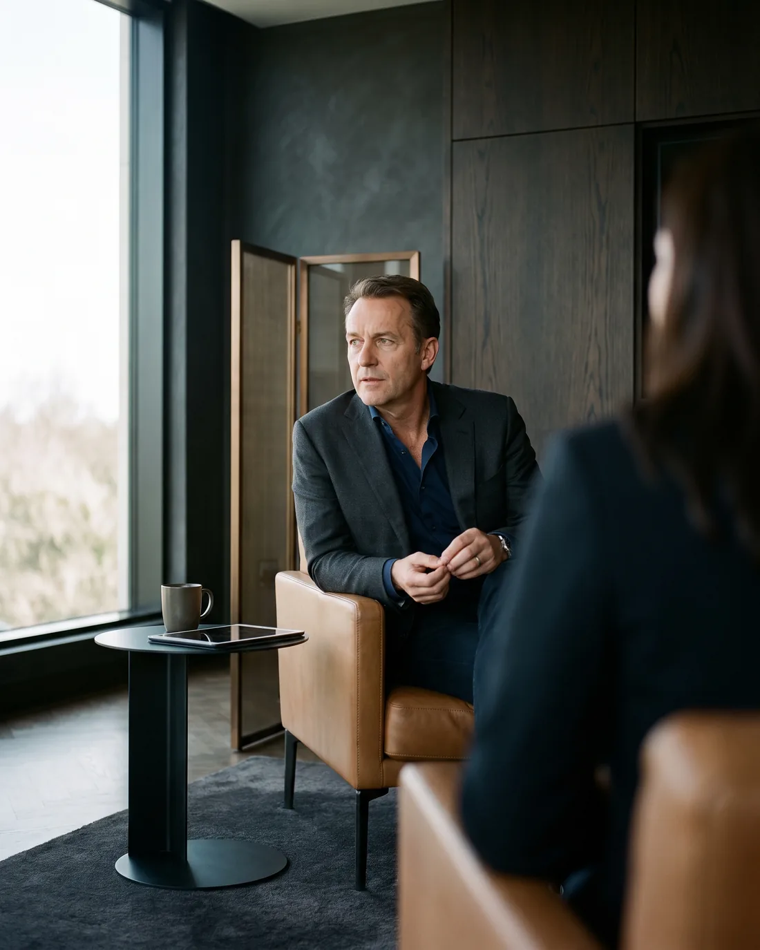 A senior CHRO reviewing the work in a calm Frankfurt boardroom